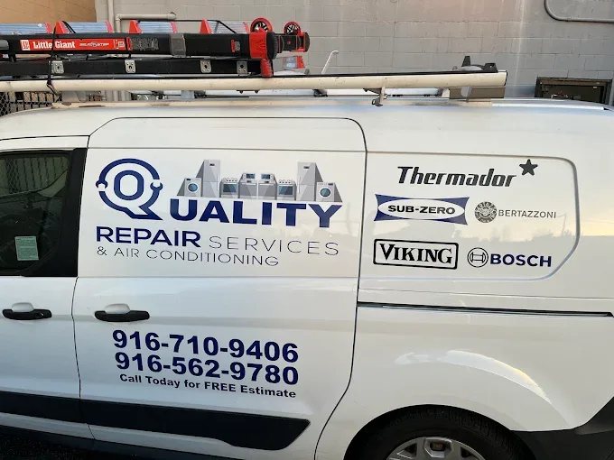 White work van with roof ladder rack lettered with vehicle graphics for Quality Repair Services & Air Conditioning, including