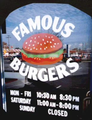 Hand-set window lettering and hours for Famous Burgers
